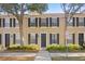 Attractive townhome featuring black shutters and a welcoming front entrance with a wreath at 9534 W Park Village Dr, Tampa, FL 33626