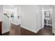 Hallway with wood floors leading to a bathroom with modern vanity and fixtures at 9534 W Park Village Dr, Tampa, FL 33626