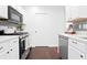 Modern kitchen featuring stainless steel appliances, quartz countertops, a tile backsplash and ample storage at 9534 W Park Village Dr, Tampa, FL 33626