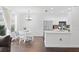 Bright kitchen and dining area with stainless steel appliances, white cabinetry and hardwood floors at 9534 W Park Village Dr, Tampa, FL 33626