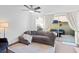 Comfortable living room featuring a sofa, ceiling fan, and sliding glass doors to patio at 9534 W Park Village Dr, Tampa, FL 33626