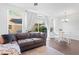 Cozy living room featuring a comfortable couch, sliding glass doors, and bright natural lighting at 9534 W Park Village Dr, Tampa, FL 33626