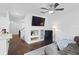 Open-concept living room with wood floors, built-in shelves, and a ceiling fan at 9534 W Park Village Dr, Tampa, FL 33626