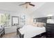Inviting main bedroom with large windows, plush bedding, and dark wood furnishings at 9534 W Park Village Dr, Tampa, FL 33626