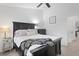 Bright primary bedroom featuring a plush bed, dark wood furnishings and a peaceful atmosphere at 9534 W Park Village Dr, Tampa, FL 33626