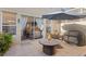 Relaxing patio with a round table, comfortable seating, and a grill, perfect for outdoor entertaining at 9534 W Park Village Dr, Tampa, FL 33626