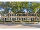 Charming townhomes featuring black shutters, well-manicured landscaping, and mature trees at 9534 W Park Village Dr, Tampa, FL 33626