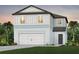 Charming two-story home with blue siding, a white garage door, and professionally landscaped yard at 9971 Trellis Vine Way, Parrish, FL 34219