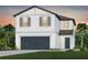 Two-story home with a modern design, attached garage, and well-manicured lawn at 9979 Trellis Vine Way, Parrish, FL 34219