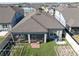 A bird's eye view of the backyard, showing a screened in porch and a well maintained grassy yard at 10303 Malvasia Ave, Riverview, FL 33578