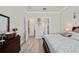 Well-lit primary bedroom offering an open doorway and a well designed dresser at 10303 Malvasia Ave, Riverview, FL 33578