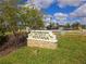 Entrance sign for The Club at Ventana set amongst green grass and trees under a sunny, partly cloudy sky at 10303 Malvasia Ave, Riverview, FL 33578