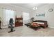 A bonus room that includes exercise equipment, natural light and detailed furniture at 10303 Malvasia Ave, Riverview, FL 33578