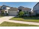 Picture of a single story home with a manicured lawn, two car garage, and beautiful garden features at 10303 Malvasia Ave, Riverview, FL 33578
