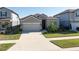 Beautiful home exterior featuring a lush front lawn, two-car garage, and elegant gray color at 10303 Malvasia Ave, Riverview, FL 33578