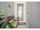 Cozy front porch sitting area with stylish seating arrangement and decorative glass front door at 10303 Malvasia Ave, Riverview, FL 33578