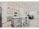 Kitchen view showing stainless steel appliances, white cabinets, and a large island with seating at 10303 Malvasia Ave, Riverview, FL 33578