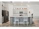 Bright kitchen with stainless steel appliances, white subway tile backsplash, and a quartz countertop island at 10303 Malvasia Ave, Riverview, FL 33578