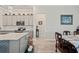 Kitchen view showcasing gray cabinets, marble backsplash, and hardwood floors, next to the dining room at 10303 Malvasia Ave, Riverview, FL 33578