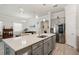 Open kitchen design featuring a central island, quartz countertops, stainless steel appliances and lots of light at 10303 Malvasia Ave, Riverview, FL 33578