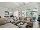 Bright living room featuring a large sectional sofa and sliding glass doors to outdoor space at 10303 Malvasia Ave, Riverview, FL 33578