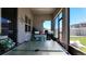 A comfortable patio furnished with seating, a glass table, and a grill with views of the fenced backyard at 10303 Malvasia Ave, Riverview, FL 33578