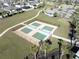 Aerial view of community pickleball courts surrounded by manicured landscaping and walking paths at 10303 Malvasia Ave, Riverview, FL 33578