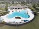 Aerial view of resort-style pool with ample seating and sunbathing areas, perfect for community enjoyment at 10303 Malvasia Ave, Riverview, FL 33578