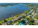 A scenic aerial view of homes along the waterfront, showcasing access to a beautiful lake and surrounding nature at 10833 96Th N St, Largo, FL 33773
