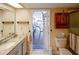 Bathroom with dual sinks and granite countertops with access to the patio at 10833 96Th N St, Largo, FL 33773