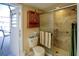 Bathroom featuring a tile shower, toilet, and access to an enclosed lanai at 10833 96Th N St, Largo, FL 33773