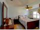 Relaxing bedroom with ceiling fan, dark wood furniture, and a comfortable queen sized bed at 10833 96Th N St, Largo, FL 33773