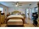 Bright bedroom with a ceiling fan, bed with matching headboard and footboard and a cushioned bench at 10833 96Th N St, Largo, FL 33773