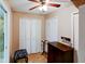 Bedroom closet with white doors, a wood shelf, and a black cushioned chair at 10833 96Th N St, Largo, FL 33773