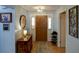 Welcoming entryway featuring a wood door, decor, a console table, and convenient shoe storage at 10833 96Th N St, Largo, FL 33773