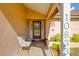 A view of a welcoming front porch with a chair and plants, showcasing the entrance to the home at 10833 96Th N St, Largo, FL 33773