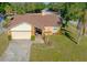Charming single Gathering home with a well maintained front yard and a driveway leading to a one car garage at 10833 96Th N St, Largo, FL 33773