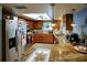 Well-lit kitchen with stainless steel appliances and granite countertops gleams at 10833 96Th N St, Largo, FL 33773
