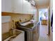 A spacious laundry room with modern washer/dryer, ample storage cabinets, and a utility sink at 10833 96Th N St, Largo, FL 33773