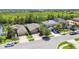 An aerial view showcases houses with palm trees and large lawns at 11506 Mansfield Point Dr, Riverview, FL 33569
