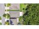 Aerial view of a home with a backyard, lush greenery, and a neighboring residence at 11506 Mansfield Point Dr, Riverview, FL 33569
