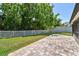 Paver patio and green lawn area are fenced in the backyard at 11506 Mansfield Point Dr, Riverview, FL 33569