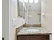 Bathroom with granite counters, mirror, and sink at 11506 Mansfield Point Dr, Riverview, FL 33569