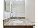 Bathroom with granite counters, mirror, and sink at 11506 Mansfield Point Dr, Riverview, FL 33569