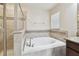 Bathroom featuring a tiled shower, soaking tub, and decorative tile accents at 11506 Mansfield Point Dr, Riverview, FL 33569