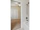 Bathroom with tub, tile wall, and view into bedroom at 11506 Mansfield Point Dr, Riverview, FL 33569