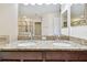 Bathroom boasts double sinks with granite counters and a view of the shower and tub at 11506 Mansfield Point Dr, Riverview, FL 33569