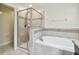 Bathroom featuring a tiled shower, soaking tub, and decorative tile accents at 11506 Mansfield Point Dr, Riverview, FL 33569
