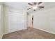 Bedroom featuring a closet, a ceiling fan, and neutral carpeting at 11506 Mansfield Point Dr, Riverview, FL 33569