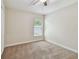 This carpeted bedroom is bright with a ceiling fan and natural light at 11506 Mansfield Point Dr, Riverview, FL 33569